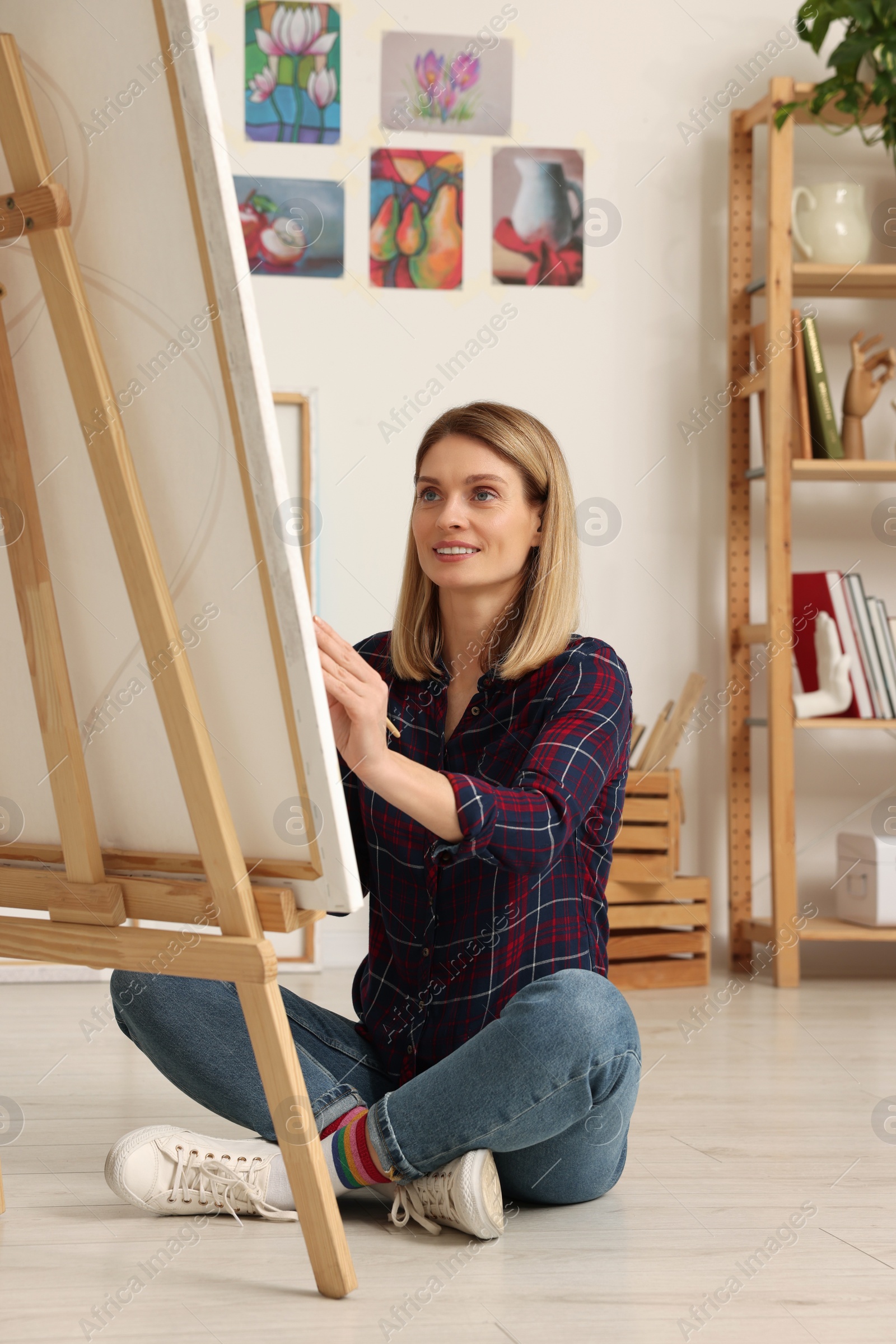 Photo of Beautiful woman painting in studio. Creative hobby