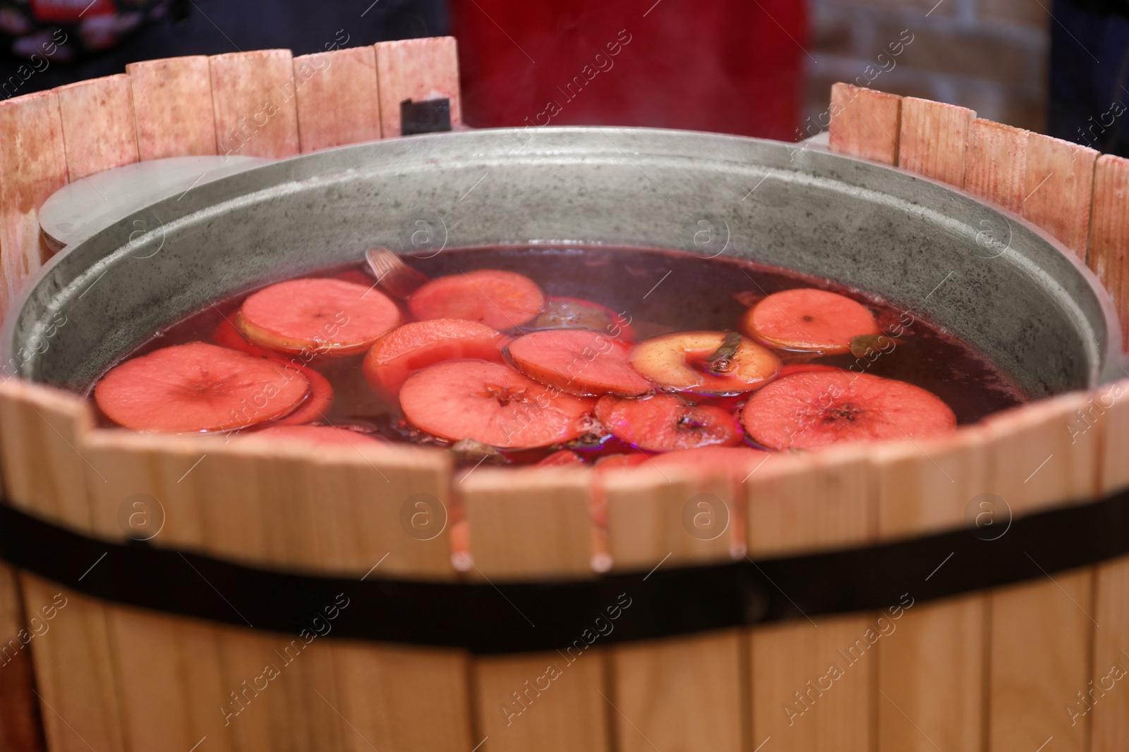 Photo of Large cauldron with tasty mulled wine at winter fair