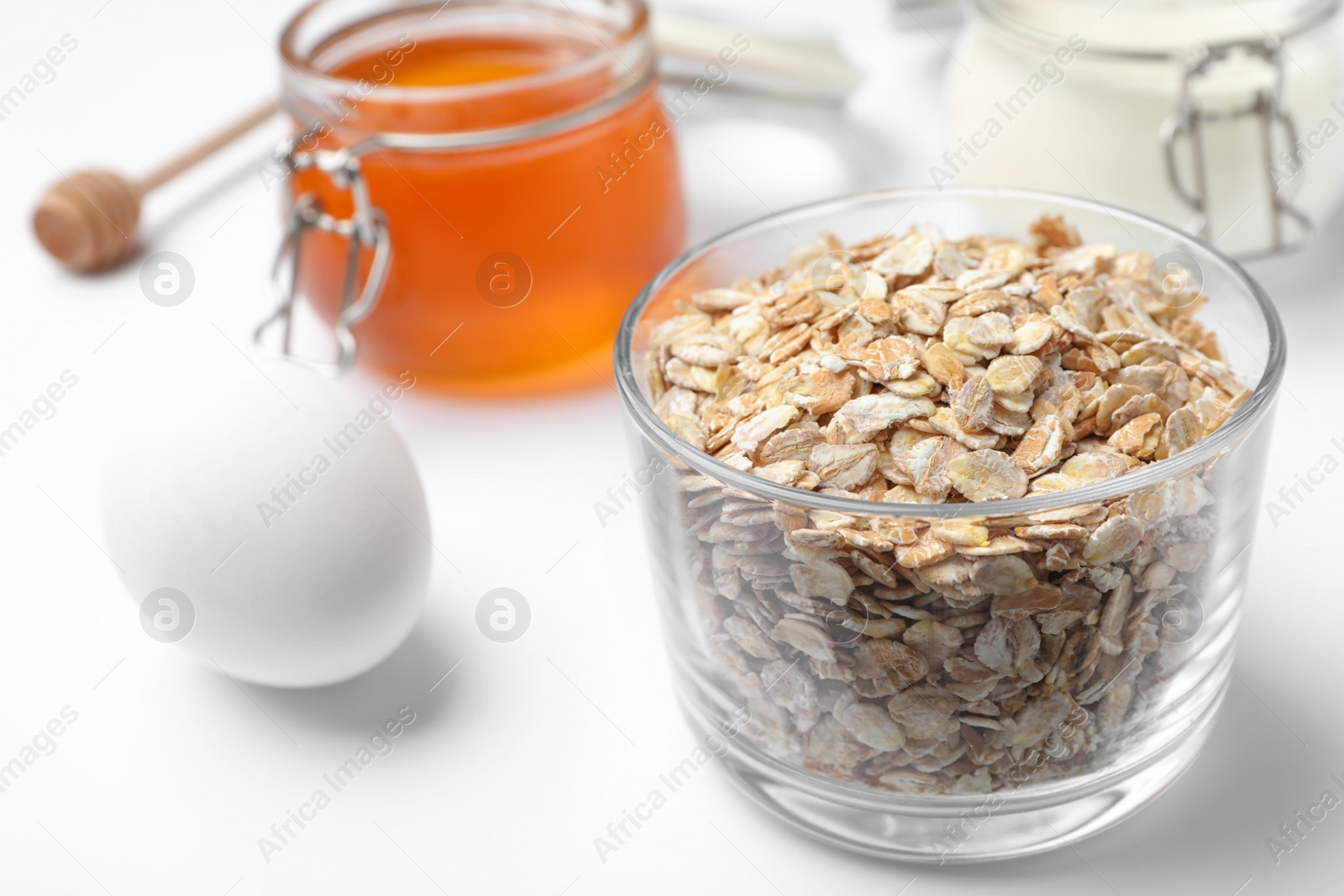 Photo of Ingredients for handmade face mask on white background, closeup