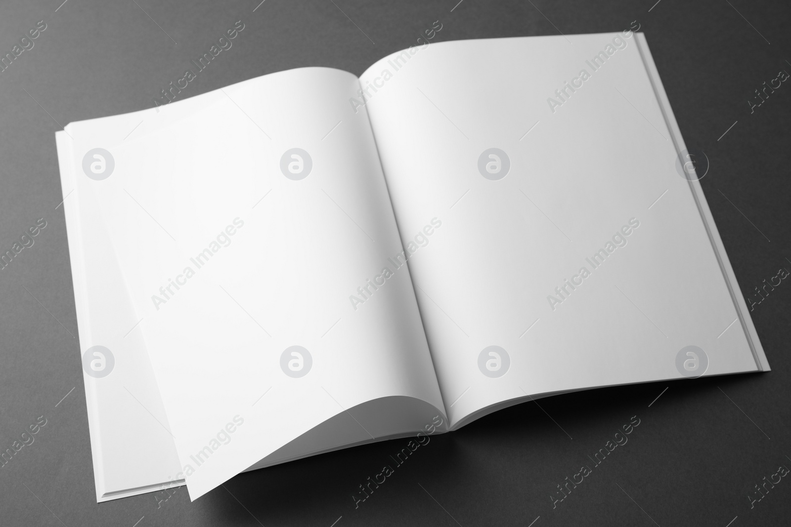 Photo of Blank book on dark grey background. Mock up for design
