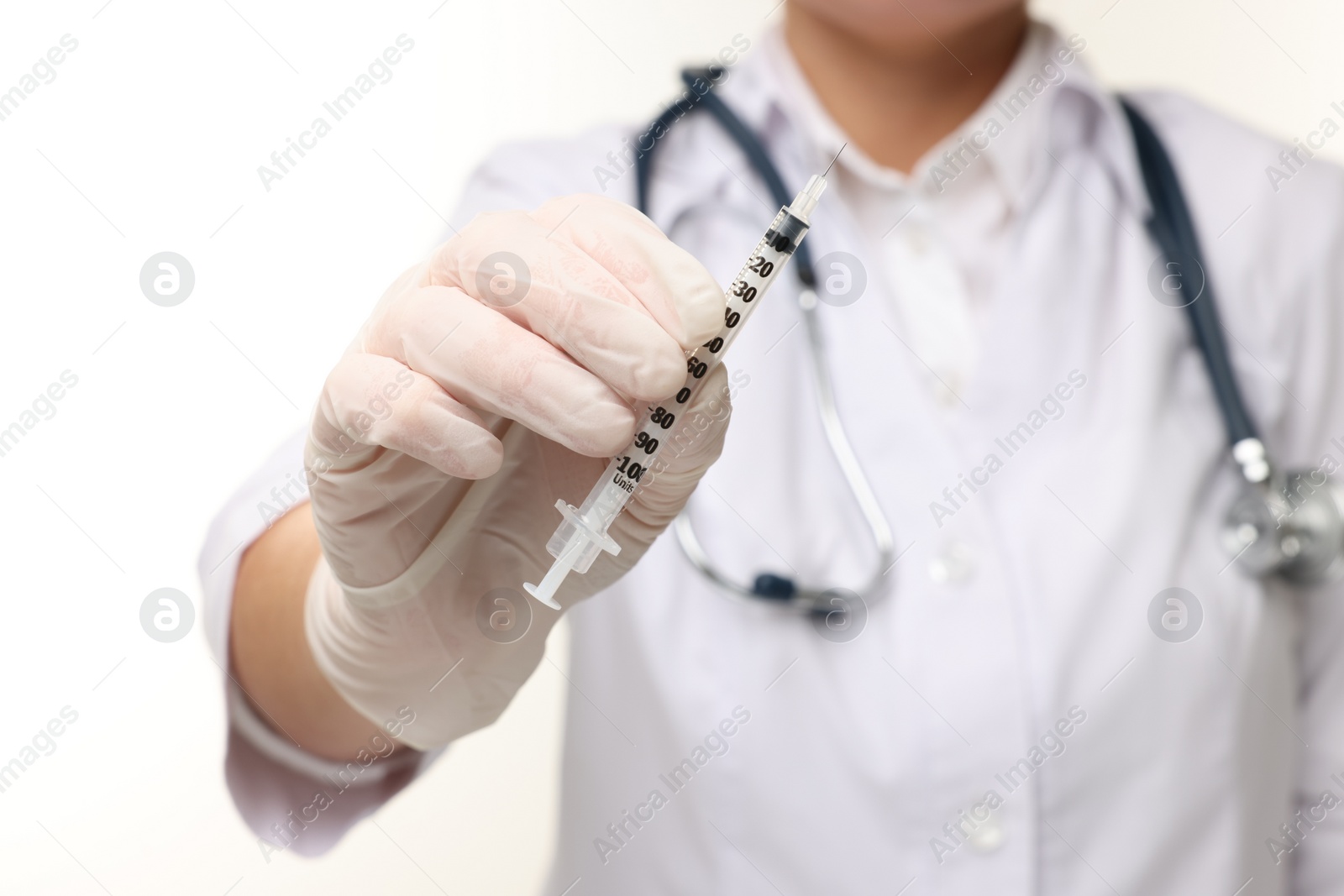 Photo of Doctor holding medical syringe on white background, closeup