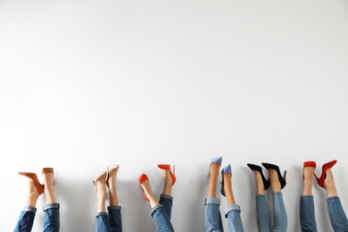 Photo of Young women in elegant shoes on white background, closeup