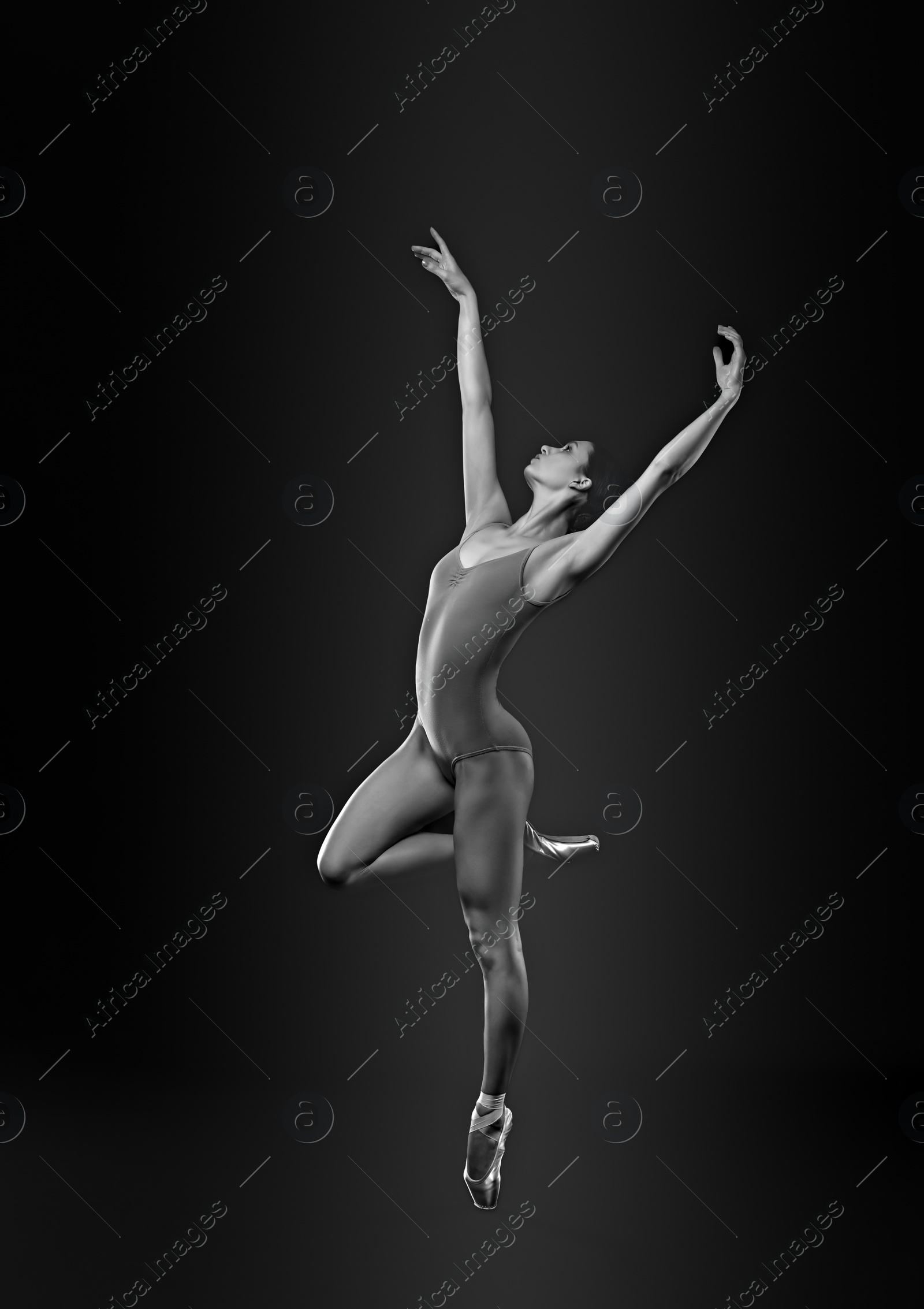 Image of Young ballerina in pointe shoes dancing. Black and white effect