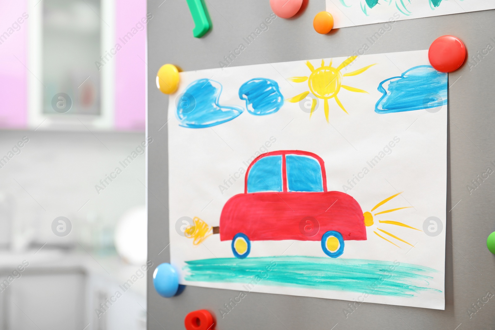 Photo of Child's drawing and magnets on refrigerator door. Space for text