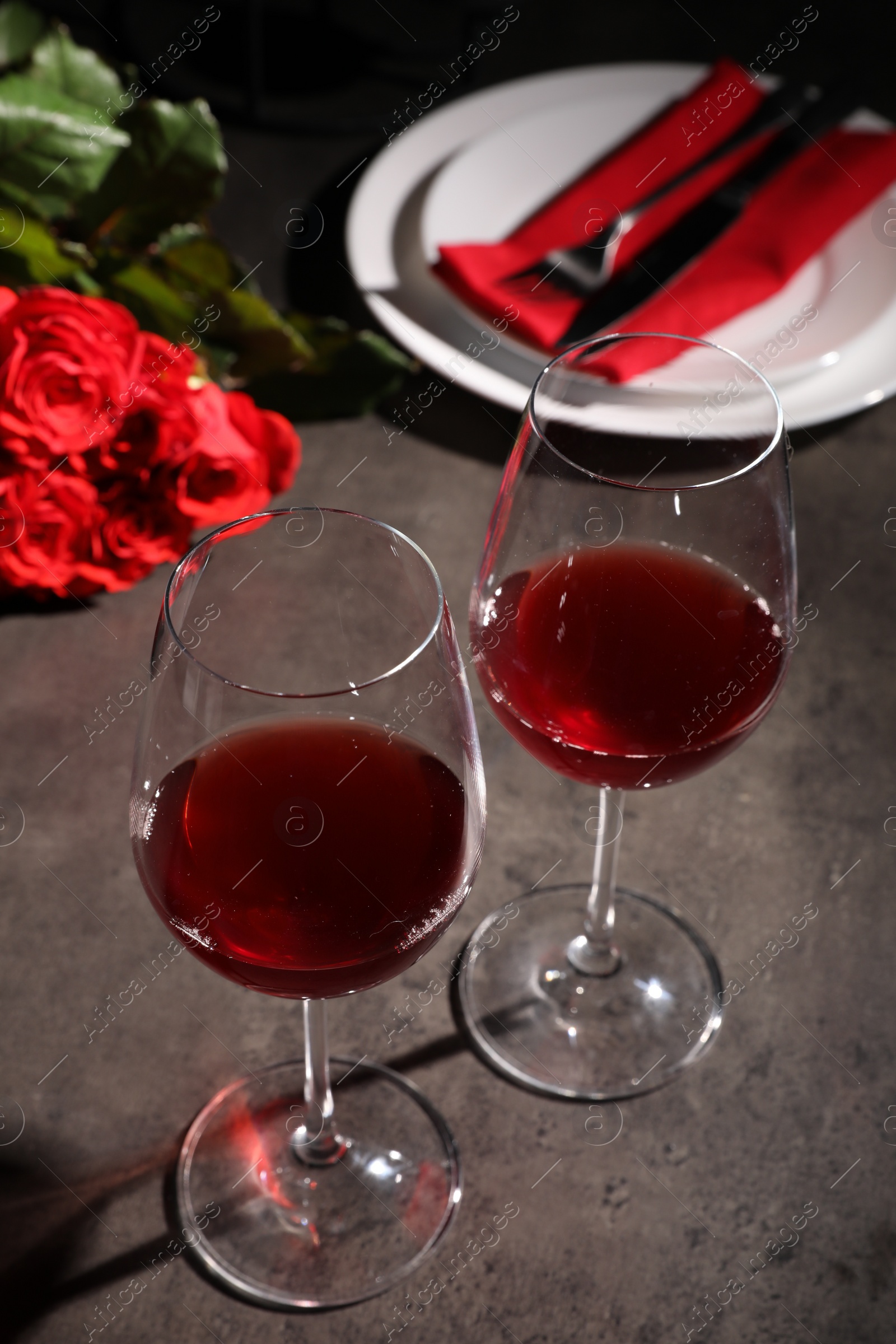 Photo of Beautiful place setting for romantic dinner on grey table