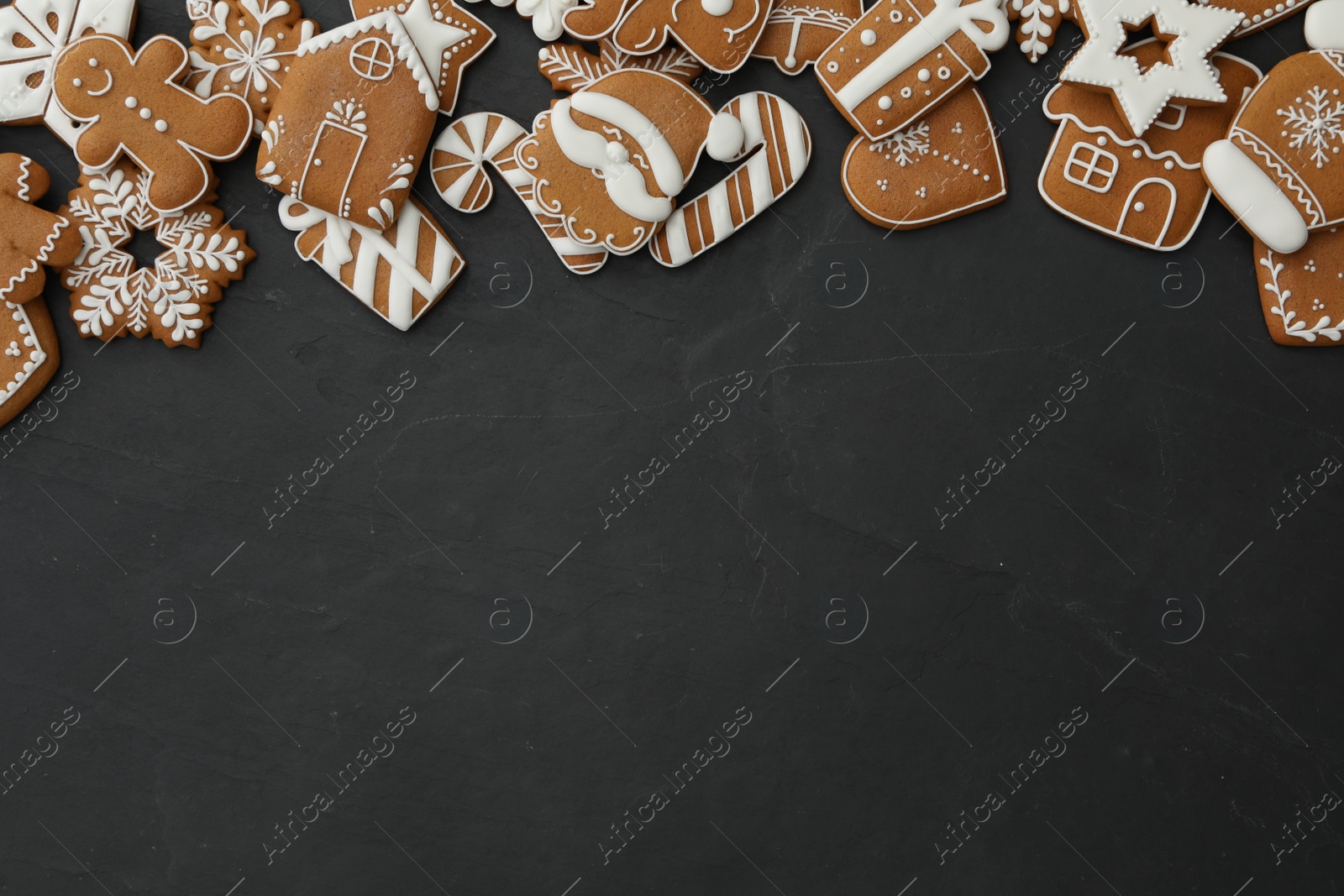 Photo of Many different delicious Christmas cookies on black table, flat lay. Space for text