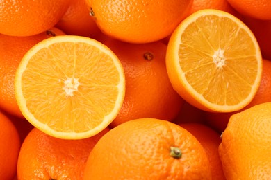 Photo of Cut and whole fresh ripe oranges as background, top view