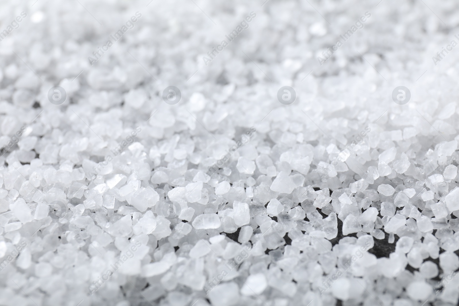 Photo of White natural salt as background, closeup view