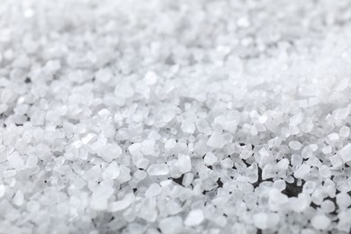 Photo of White natural salt as background, closeup view