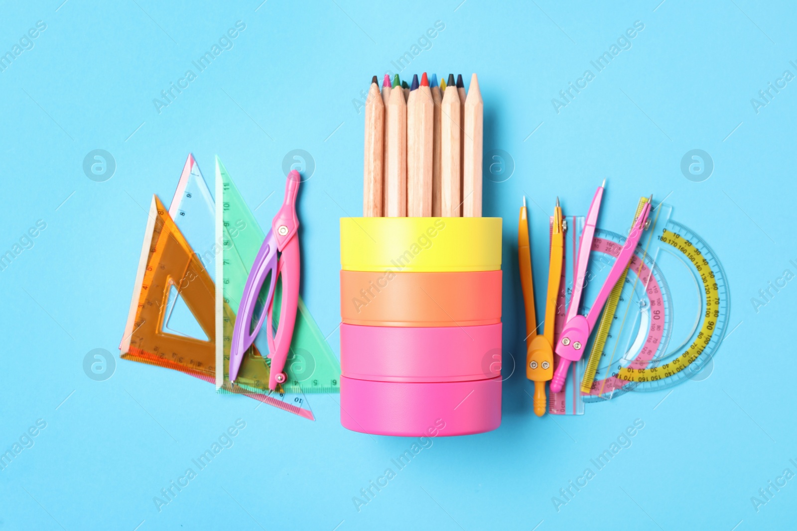 Photo of Different stationery on light blue background, flat lay. Back to school