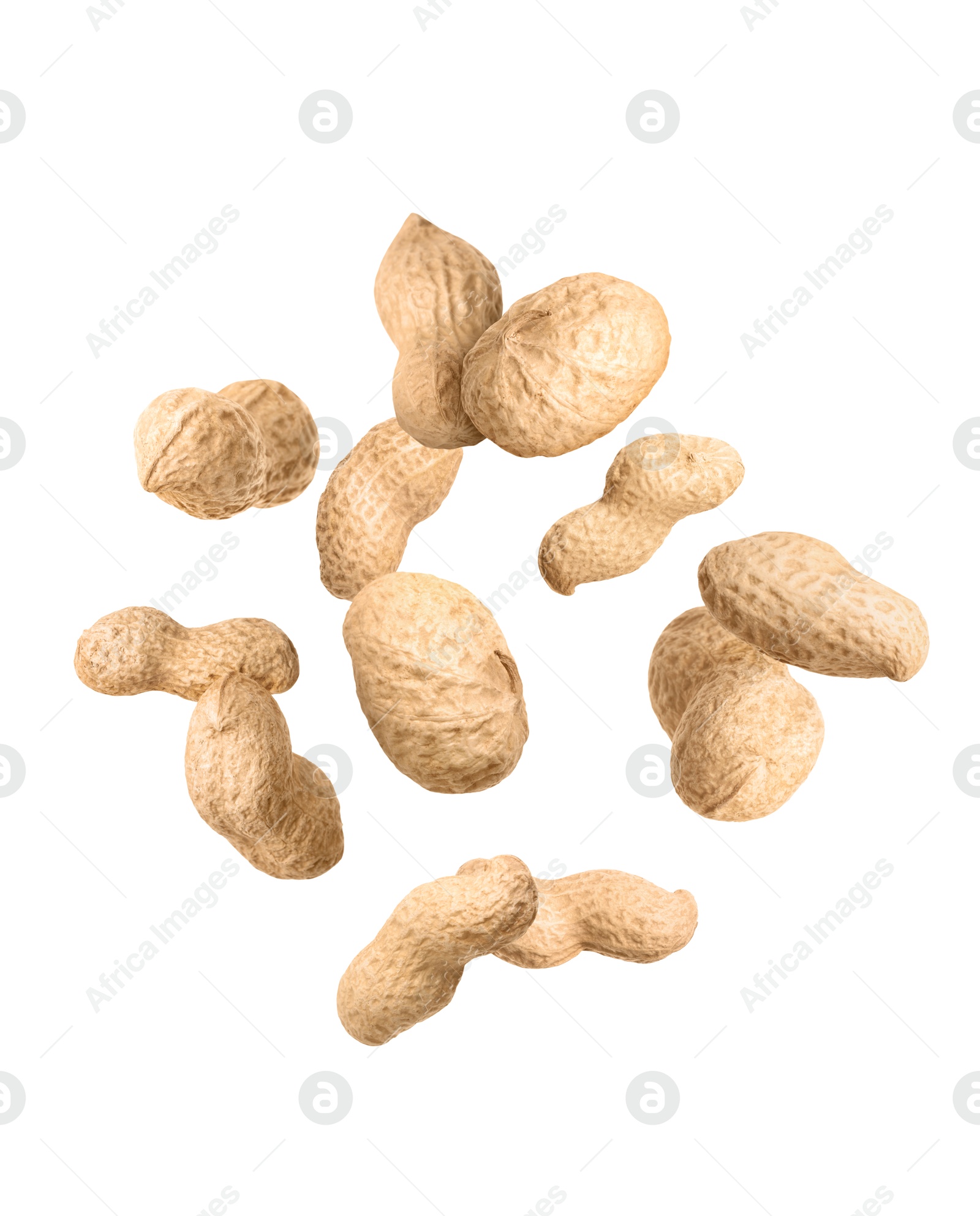 Image of Unpeeled peanuts in air on white background