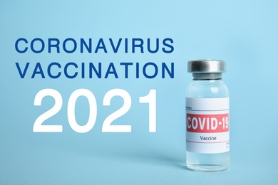 Image of Vial with coronavirus vaccine on light blue background 