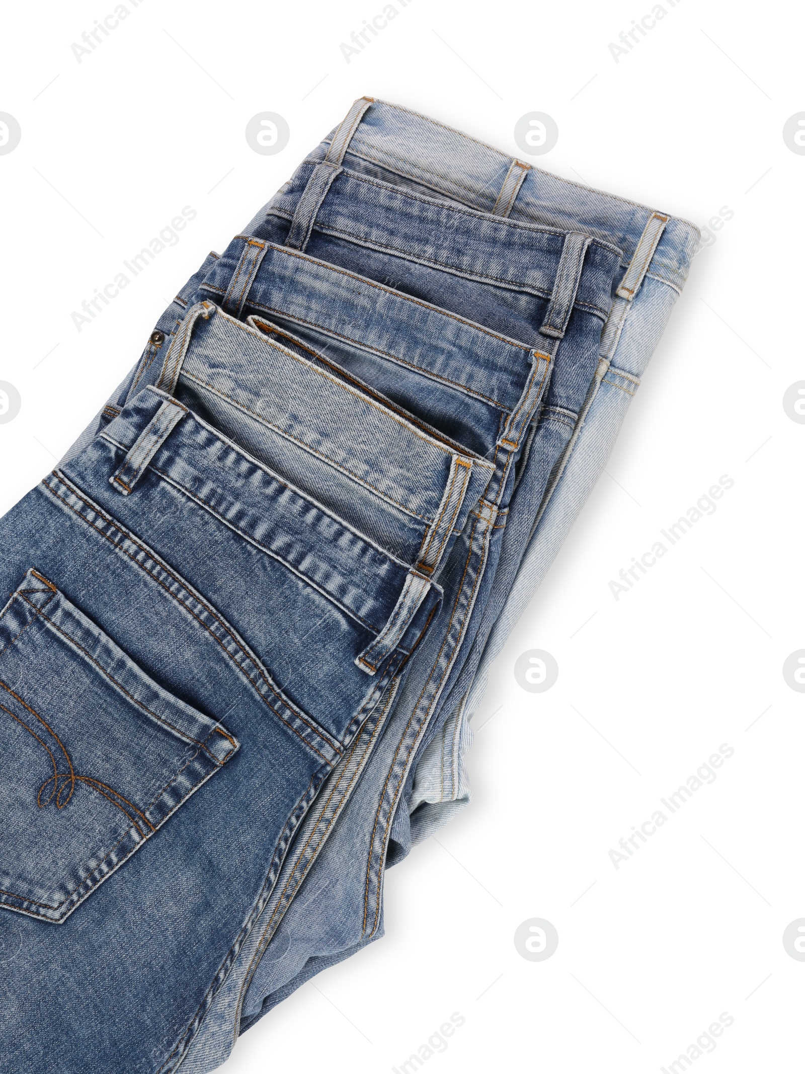 Photo of Different stylish jeans isolated on white, top view