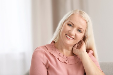 Portrait of beautiful older woman against blurred background