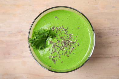 Tasty kale smoothie with chia seeds on wooden table, top view