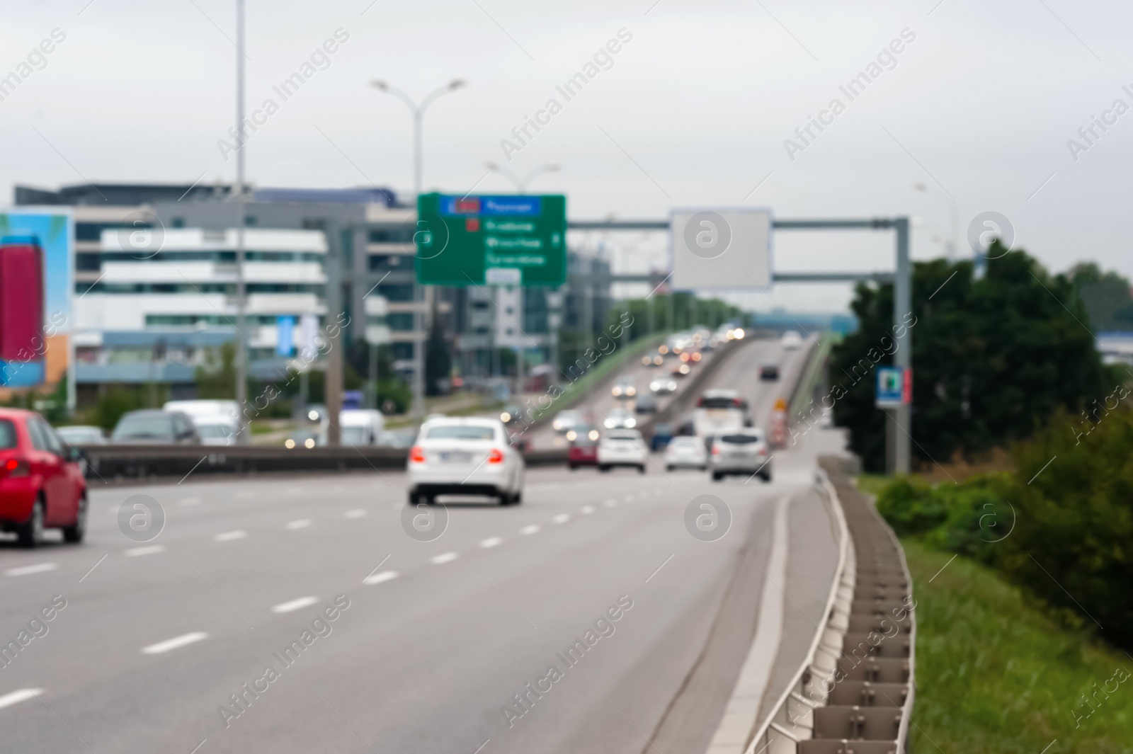 Photo of Blurred view of city road with cars