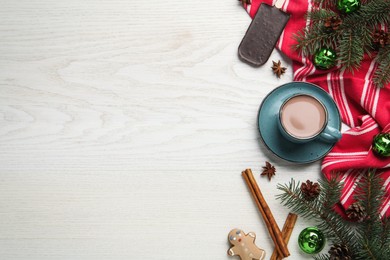 Delicious hot chocolate and Christmas decor on white wooden table, flat lay. Space for text