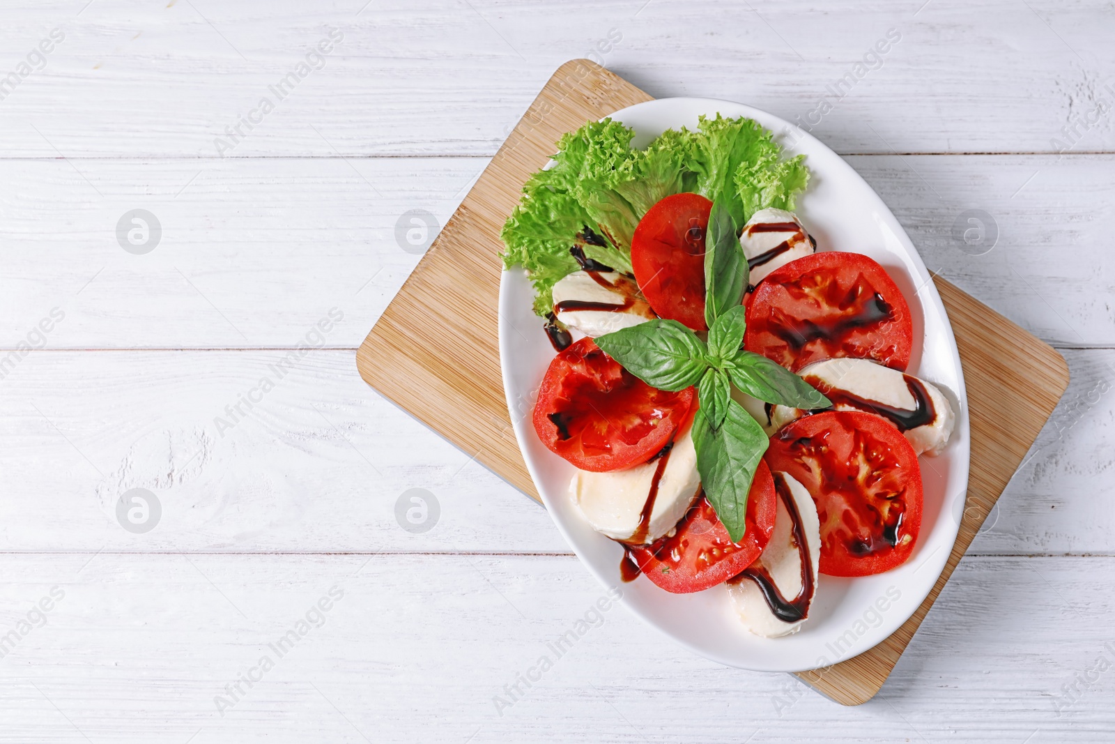 Photo of Plate with delicious fresh salad on table, top view