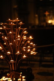 Florence, Italy - February 8, 2024: Burning candles in Santa Maria Del Fiore, closeup