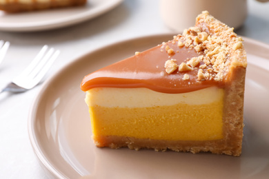 Piece of delicious cake with caramel on table, closeup