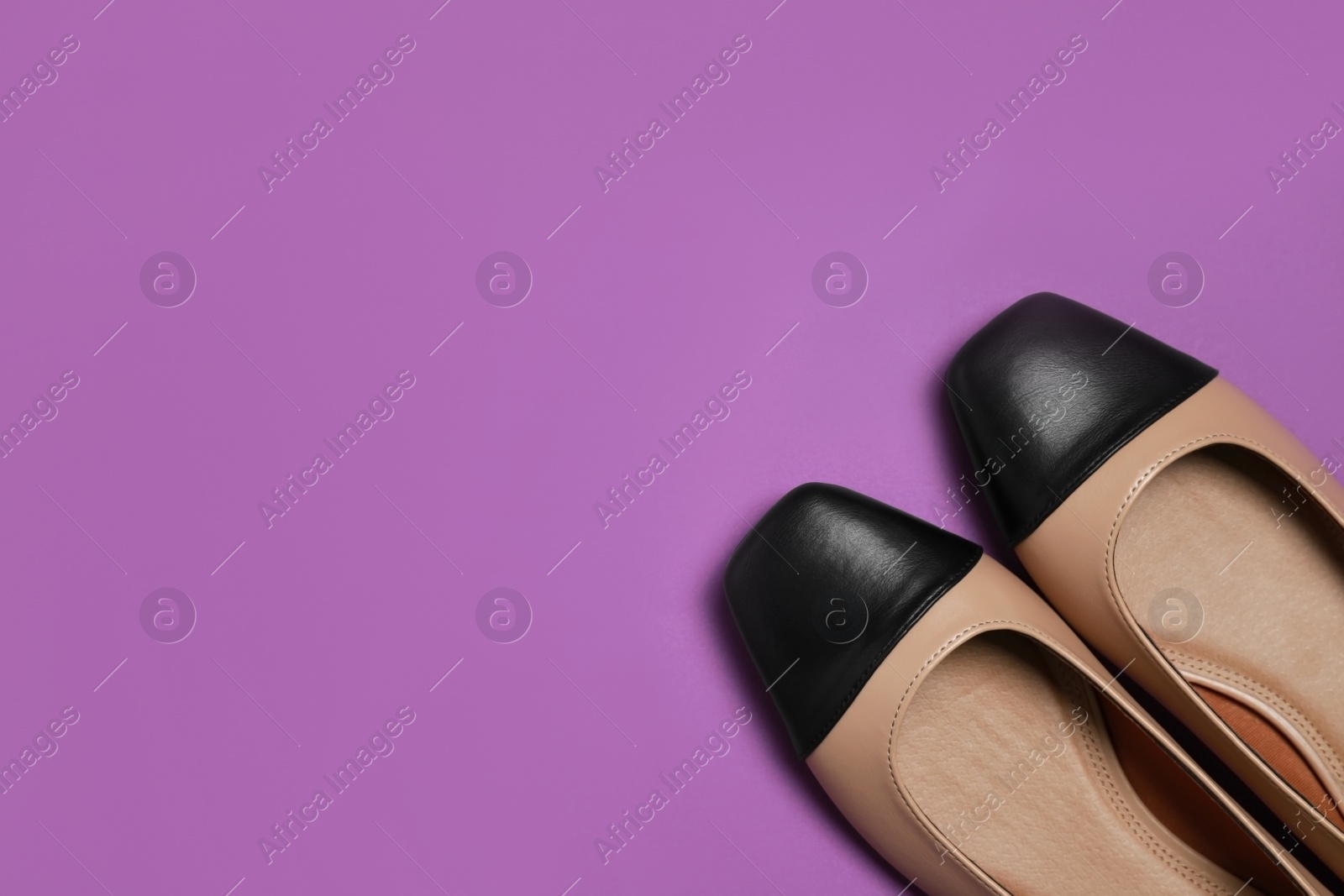 Photo of Pair of new stylish square toe ballet flats on purple background, flat lay. Space for text