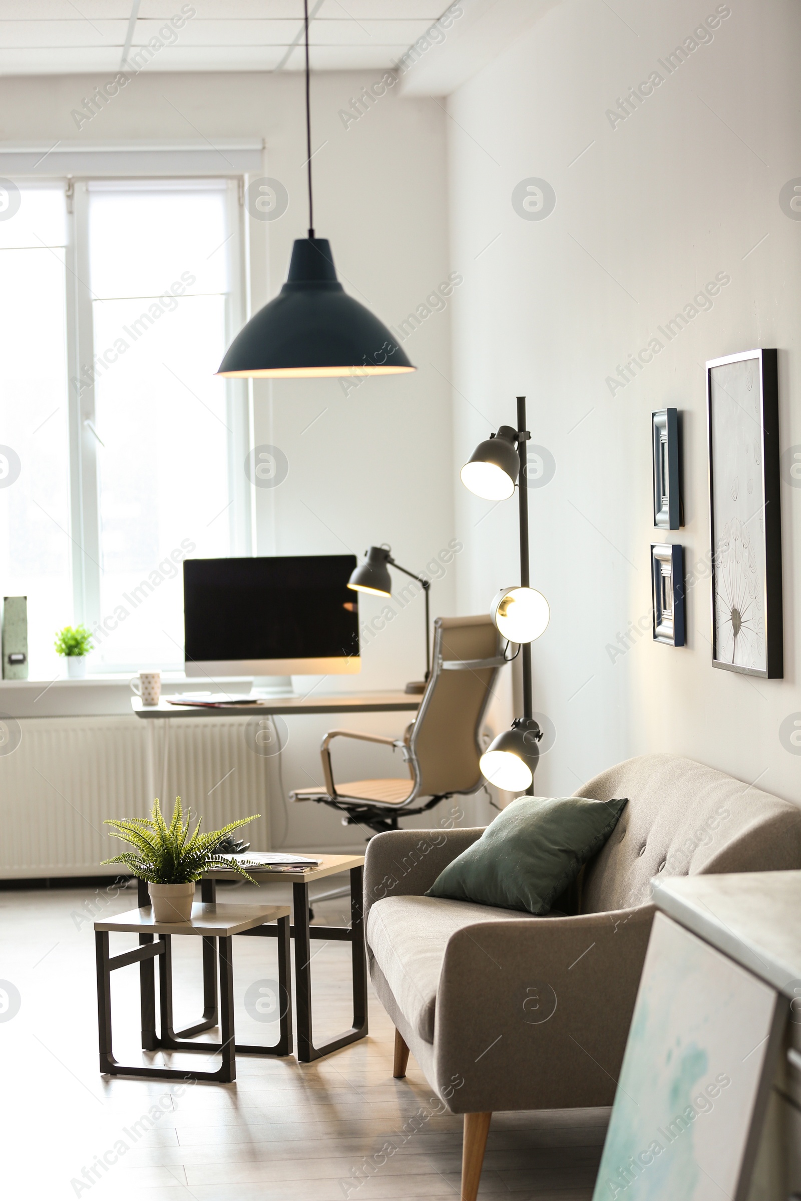 Photo of Room interior with modern lamps and comfortable sofa