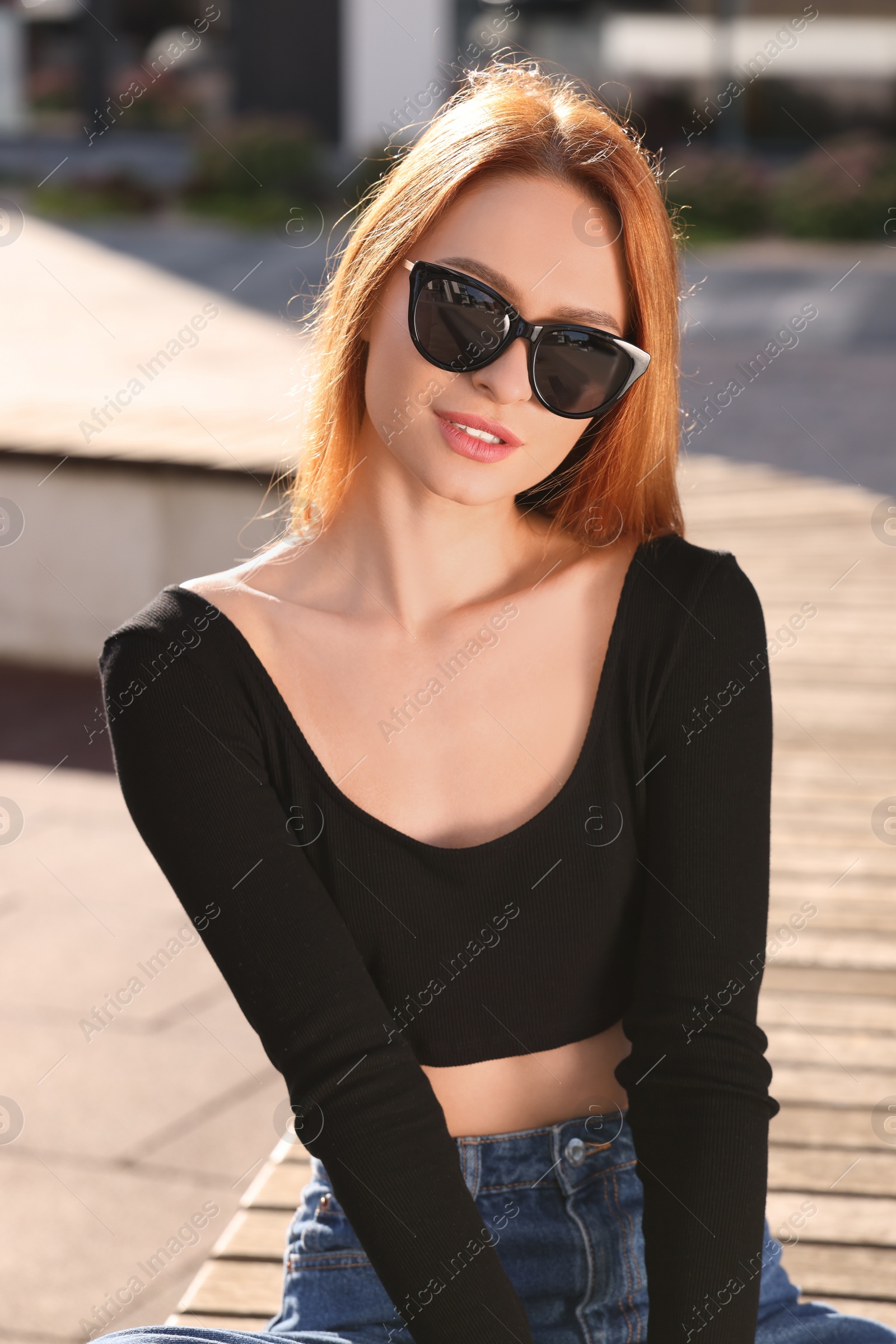 Photo of Beautiful woman in sunglasses outdoors on sunny day