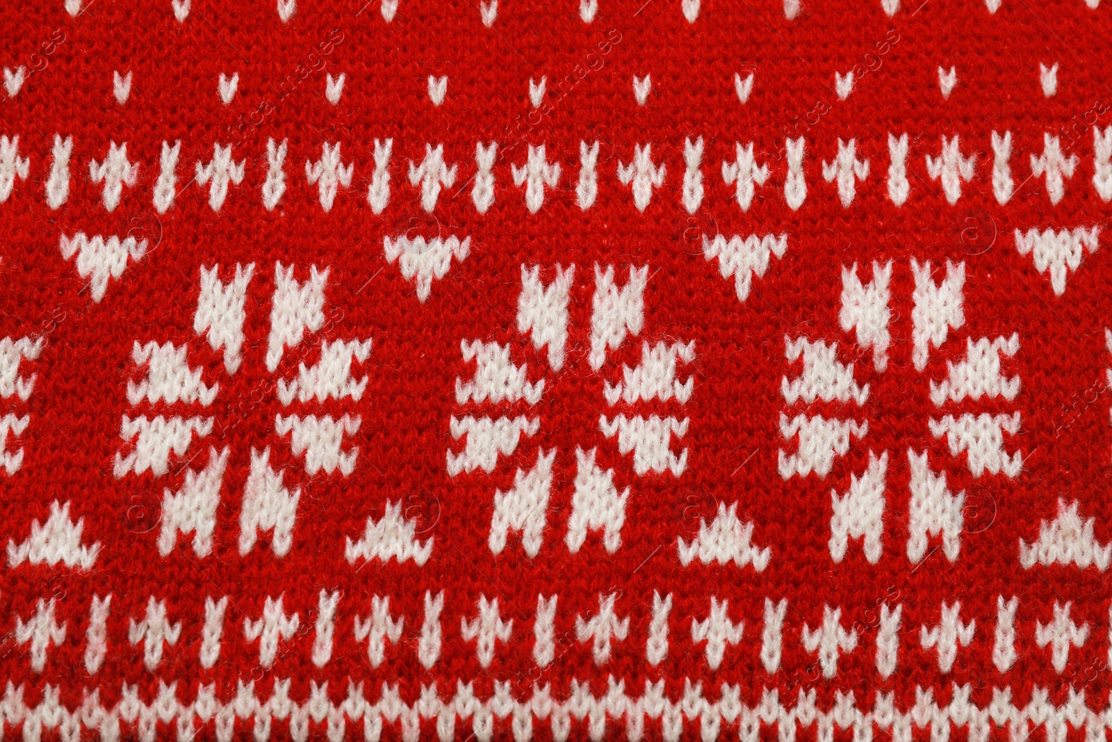 Photo of Warm red Christmas sweater as background, closeup view