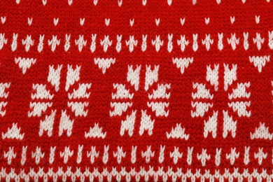 Photo of Warm red Christmas sweater as background, closeup view