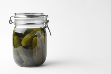 Jar with pickled cucumbers on white background