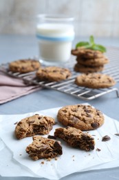 Photo of Tasty chocolate chip cookies on light grey table