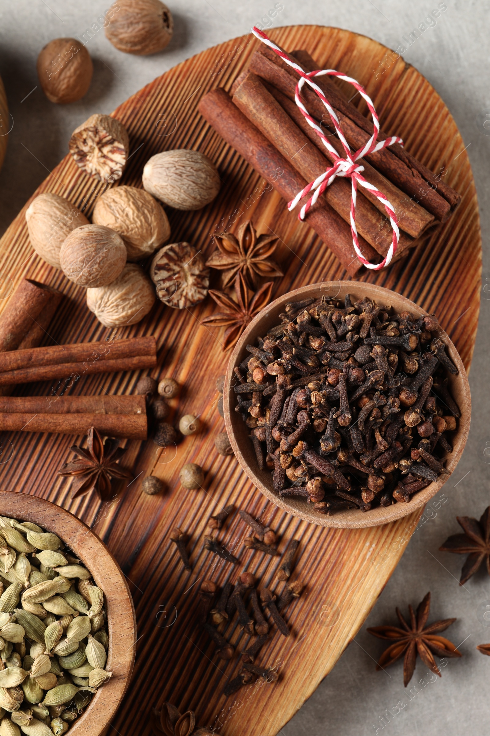 Photo of Different spices on light gray table, top view