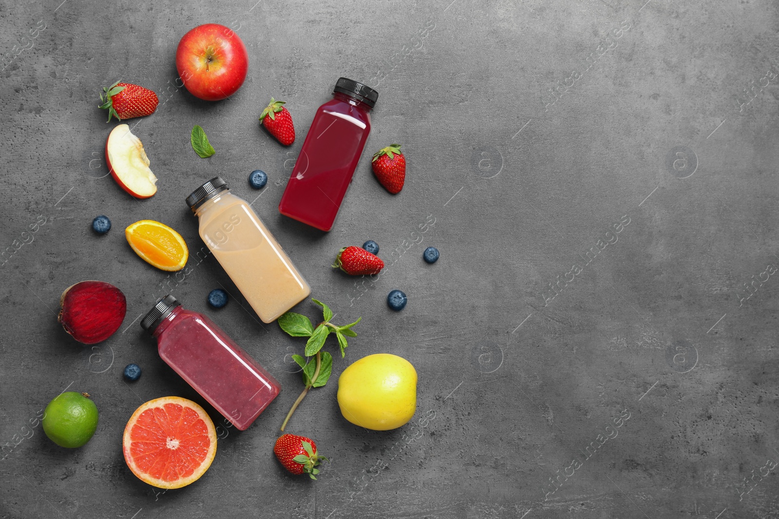 Photo of Flat lay composition with healthy detox smoothies and ingredients on grey background