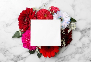 Photo of Flat lay composition with beautiful dahlia flowers and blank card on white marble background, flat lay. Space for text