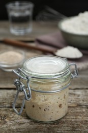 Photo of Leaven in glass jar on wooden table