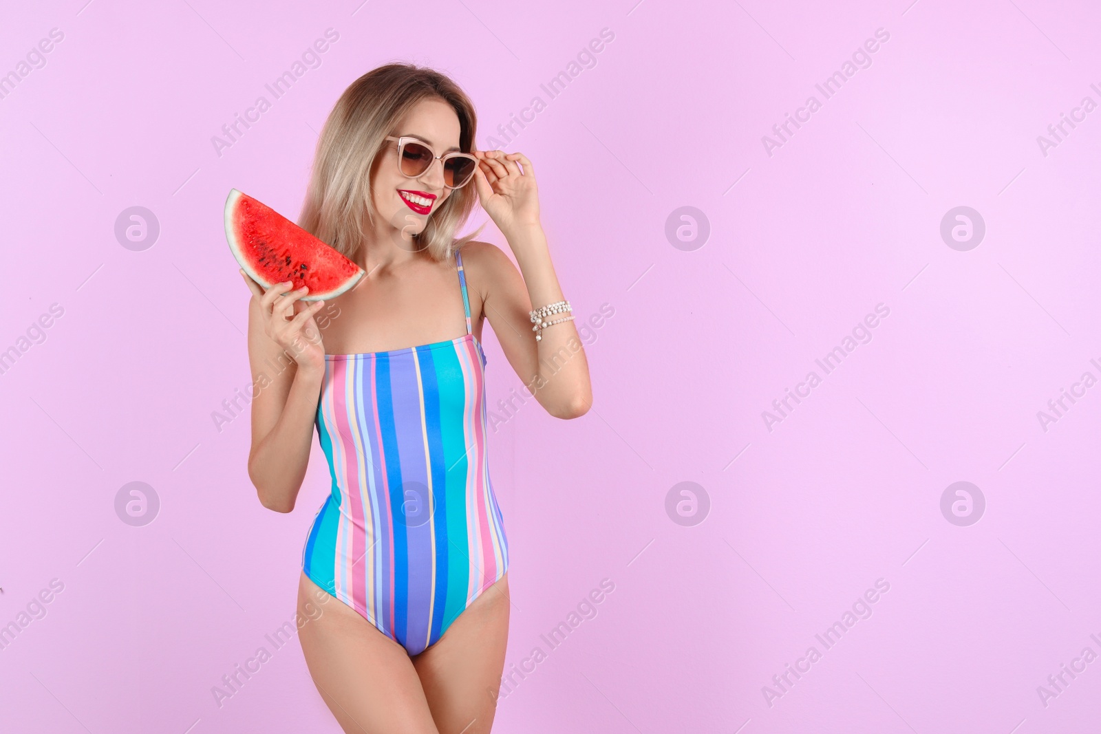 Photo of Pretty young woman with juicy watermelon on color background