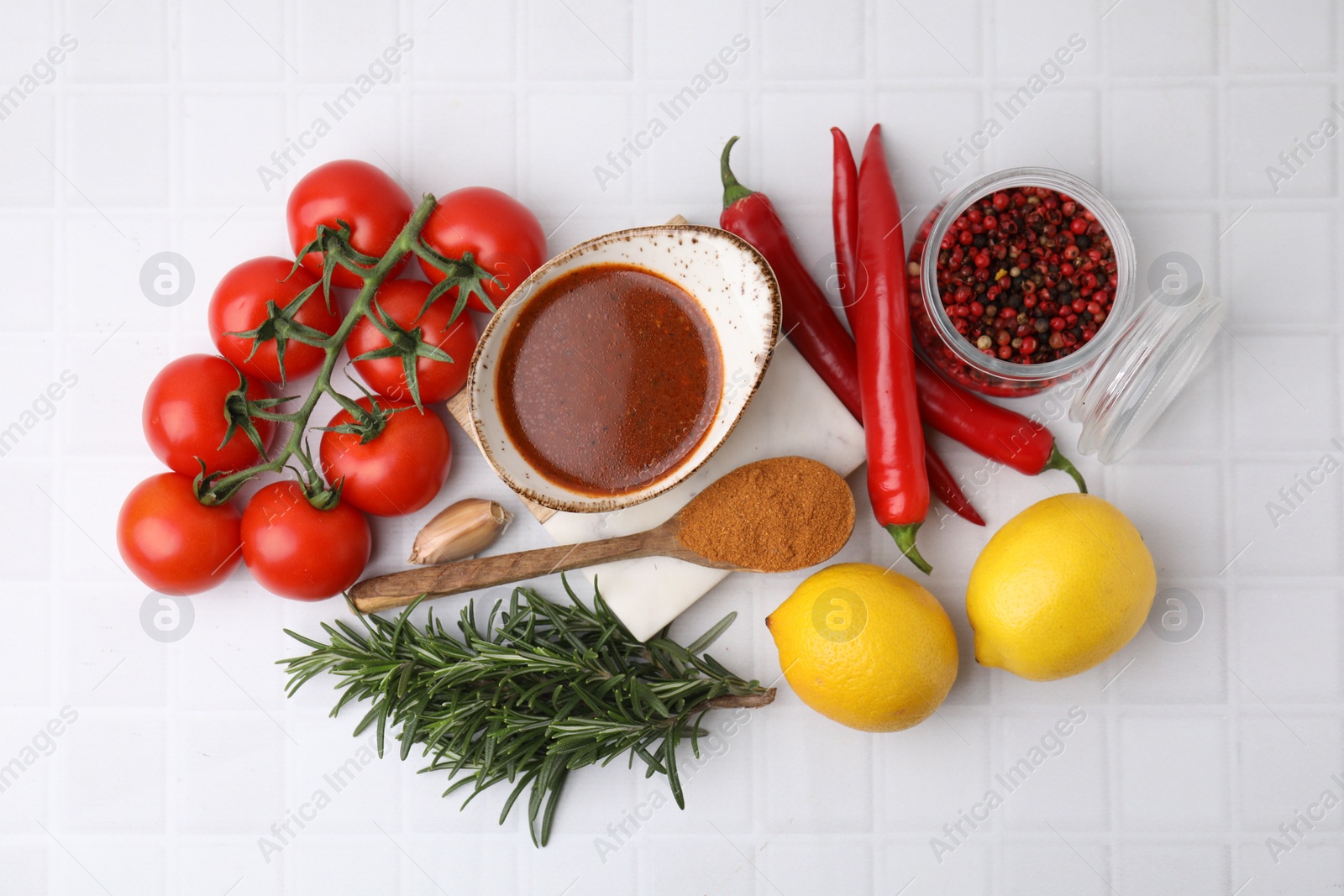 Photo of Flat lay composition with fresh marinade and different ingredients on white tiled table