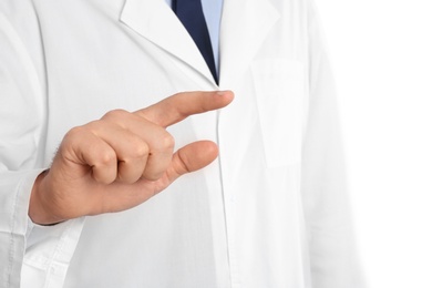 Male doctor pointing on white background, closeup