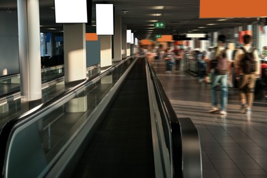 Photo of Interior of airport terminal with travelator. Air travel