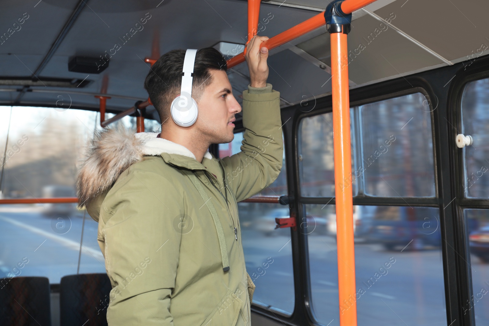 Photo of Man listening to audiobook in trolley bus