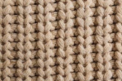 Photo of Beautiful beige knitted fabric as background, top view