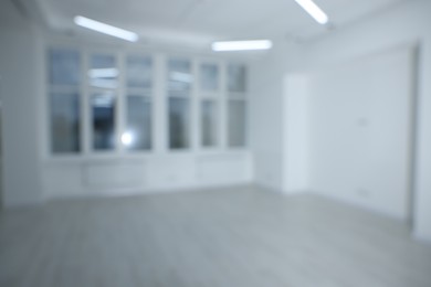 Photo of Blurred view of new empty room with windows