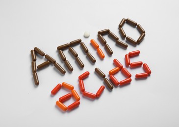 Photo of Words "AMINO ACIDS" made with pills on white background
