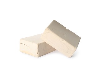 Photo of Blocks of compressed yeast on white background