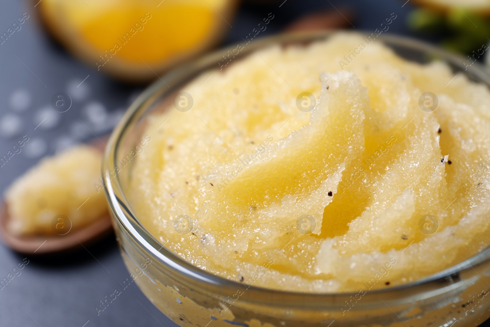 Photo of Body scrub in glass bowl on table, closeup