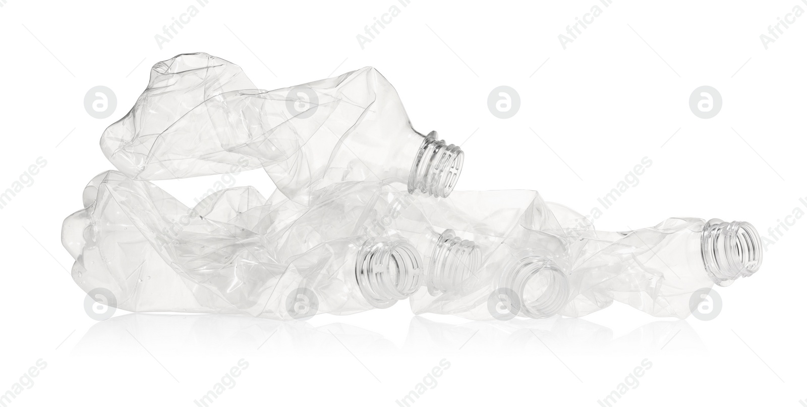 Photo of Crumpled disposable plastic bottles isolated on white