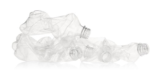 Photo of Crumpled disposable plastic bottles isolated on white