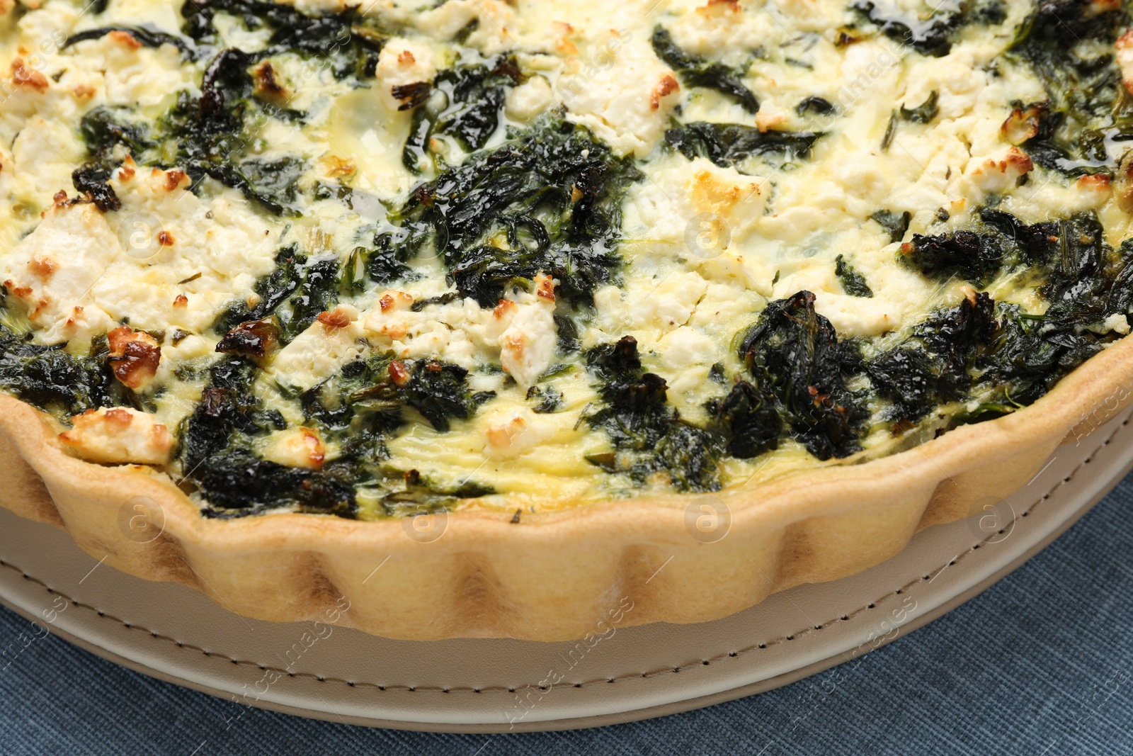 Photo of Delicious homemade spinach quiche on table, closeup