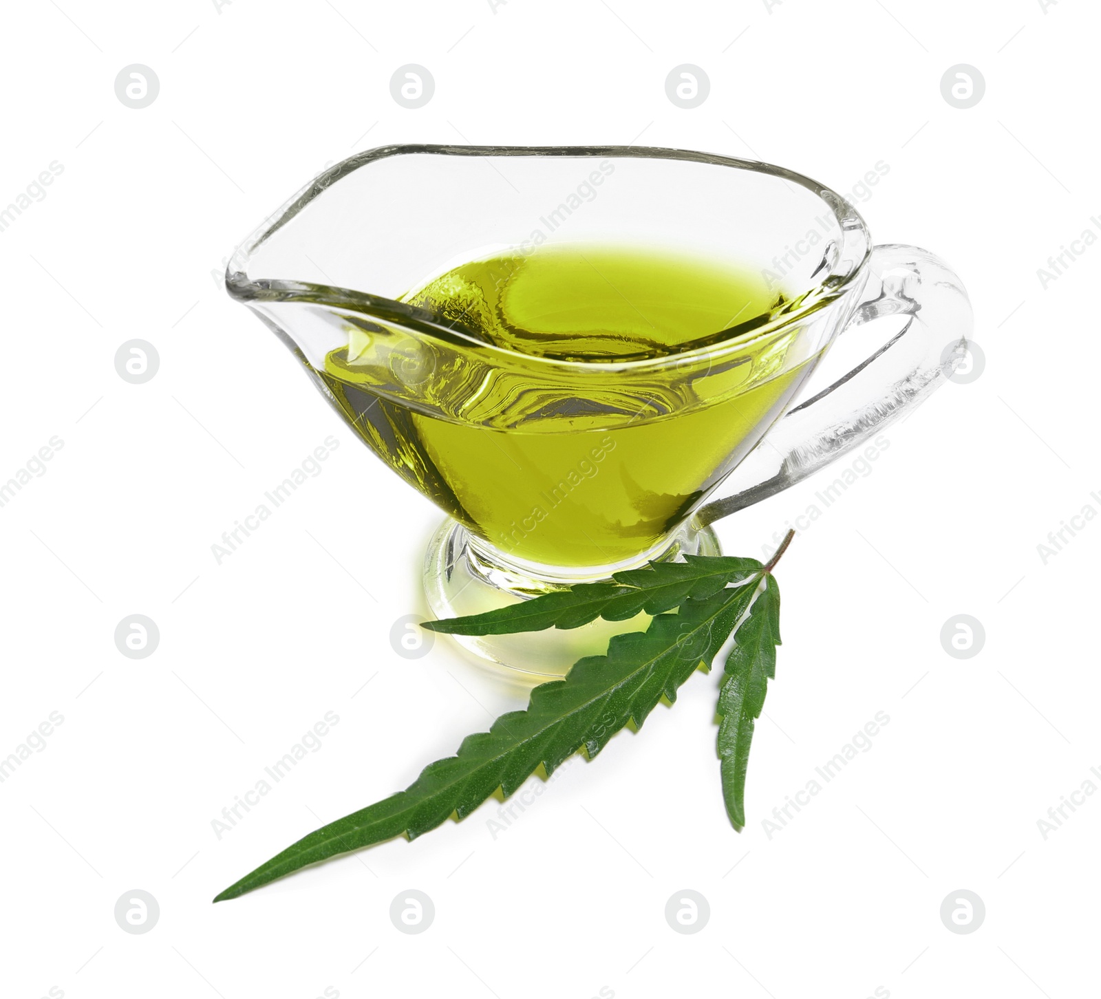 Photo of Gravy boat with hemp oil and leaf on white background