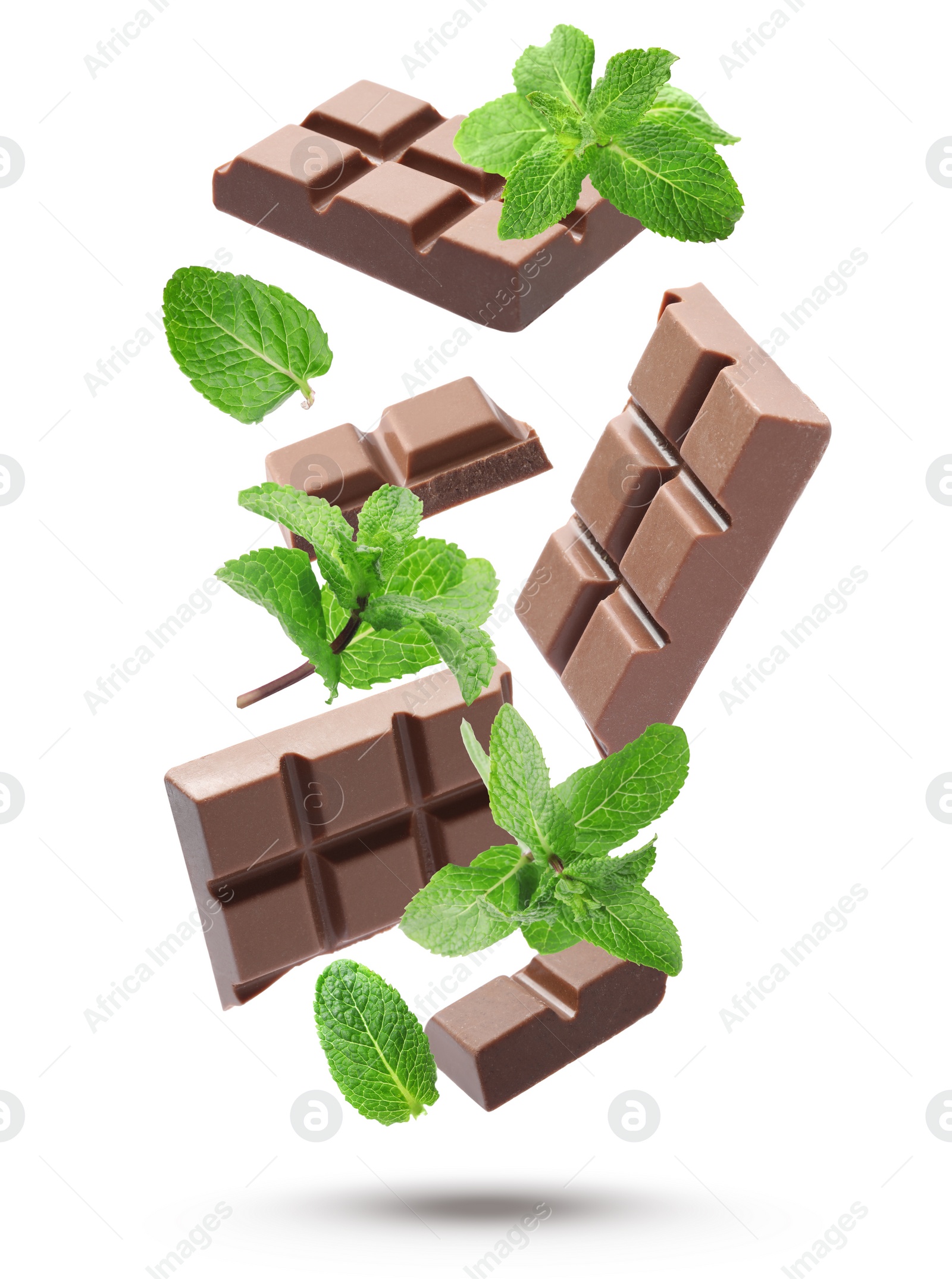 Image of Milk chocolate pieces and mint falling on white background